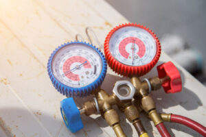 image of an hvac contractor examining ac unit refrigerant levels