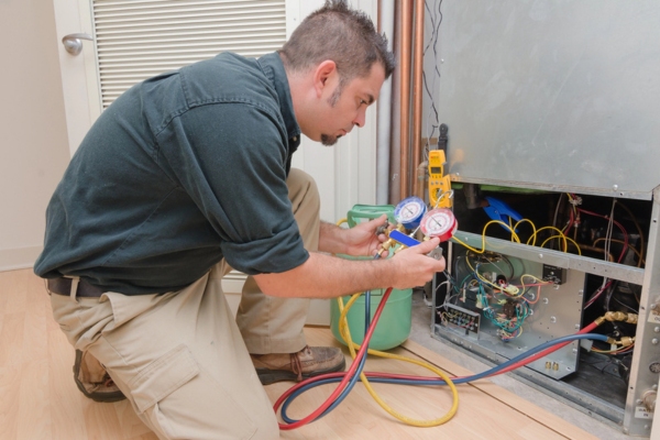 HVAC technician working on a refrigerant leak of an air conditioning system