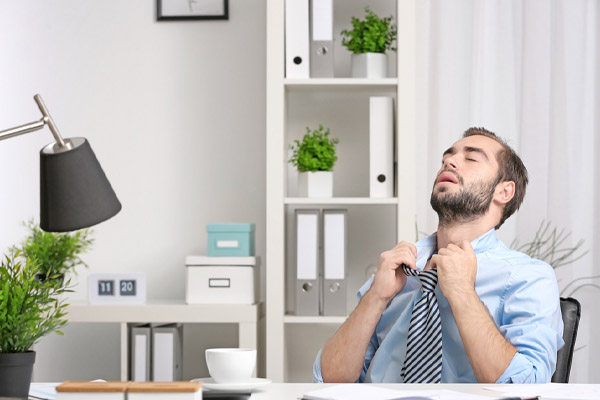image of a man feeling hot and uncomfortable due to ac blowing warm air