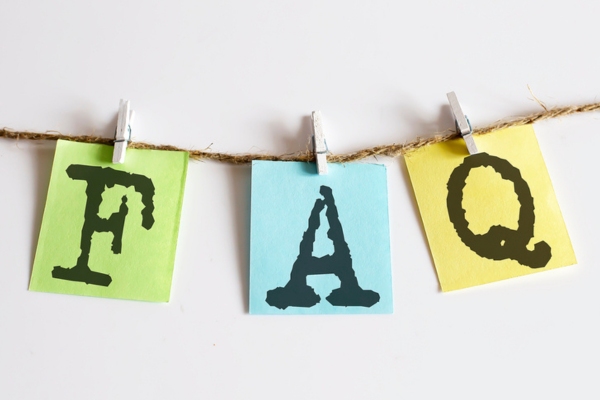 FAQ on colored paper clipped on a thin rope depicting questions about Air Conditioner Life Expectancy
