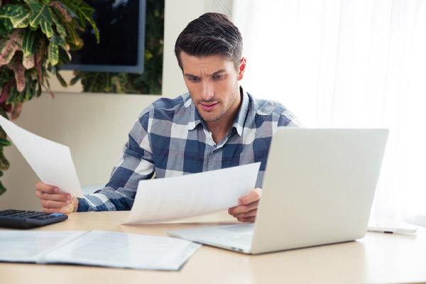 image of a homeowner looking at heating oil costs and calculating heating oil consumption