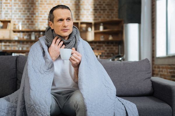 image of a homeowner feeling chilly due to boiler shutdown
