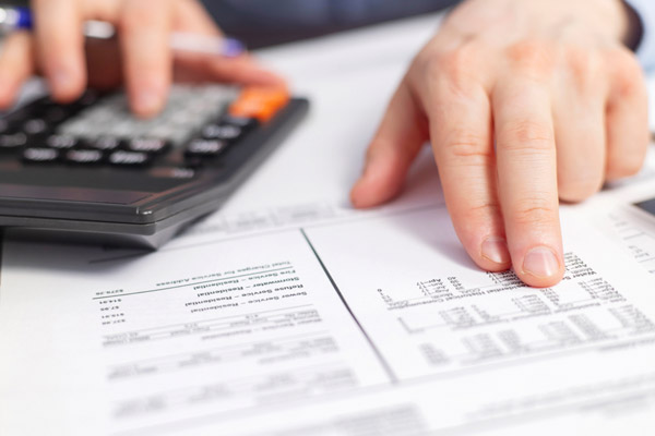 image of homeowner calculating home heating costs and heating system efficiency