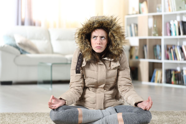 image of a homeowner feeling chilly due to furnace issues