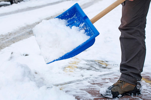 shoveling snow for winter home heating oil delivery