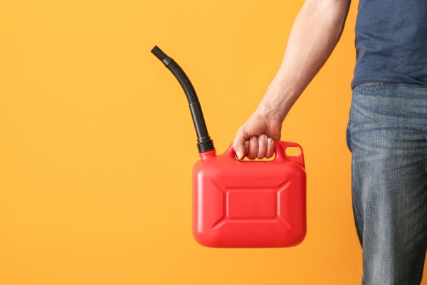 Man holding diesel canister with rubber nozzle