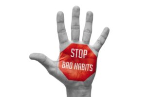 Stop Bad Habits stamped on hand depicting poor air conditioner care