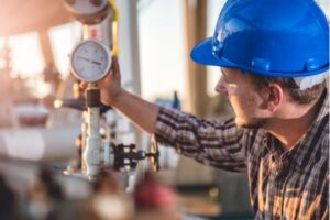 man checking propane tank gauge