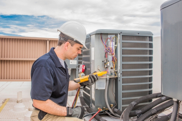 HVAC technician servicing air conditioner