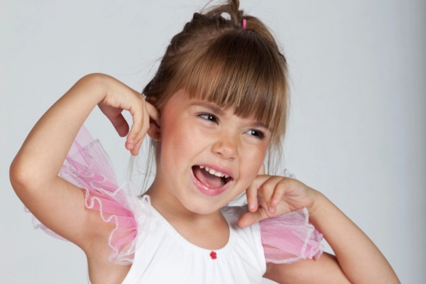 kid covering ear with fingers depicting noise levels consideration
