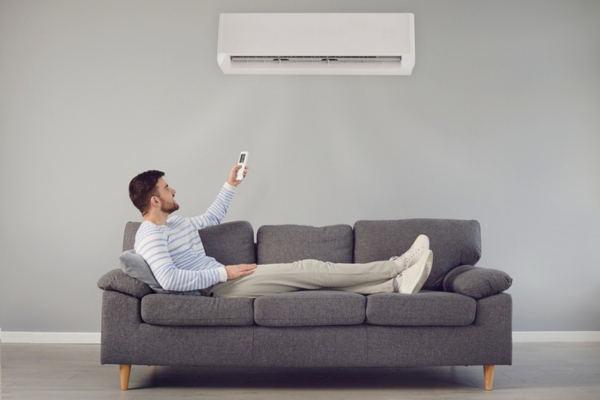 man controlling ductless HVAC system