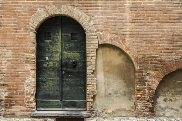 front door of an old house with bricks for walls