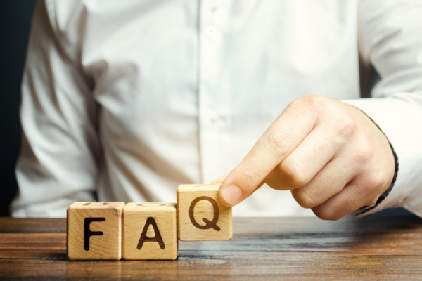 man spelling FAQ using wooden letter cubes depicting questions when AC Unit Isn’t Blowing Cold Air