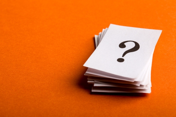 question mark on a stack of paper depicting FAQs about Heating Oil in Summer