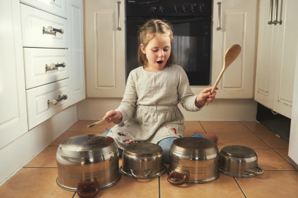 little girl banging pots depicting furnace noise