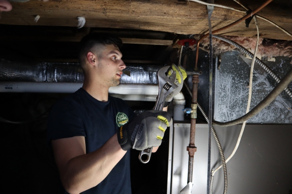Lake Region Energy HVAC technician inspecting heating system due to overheating furnace
