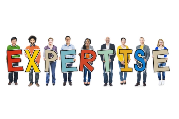 people holding colorful cutout letters that spells EXPERTISE