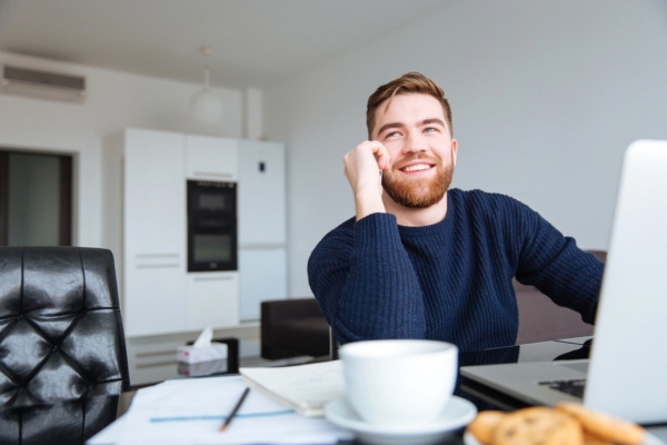 man calling for oil delivery at home