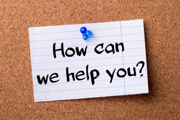 How can we help you written on a note pinned on a corkboard