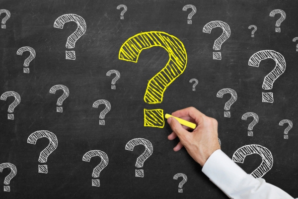 question marks doodled on a chalkboard depicting HVAC End-of-Winter Tips FAQs