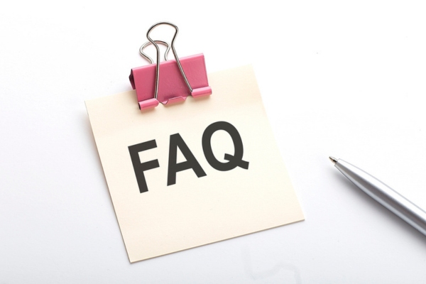 FAQ written on a mini paper with a metal clip on topdepicting HVAC Maintenance Agreements questions