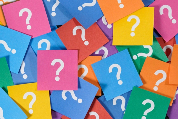question marks on colored papers depicting FAQs About Propane Tank Landscaping
