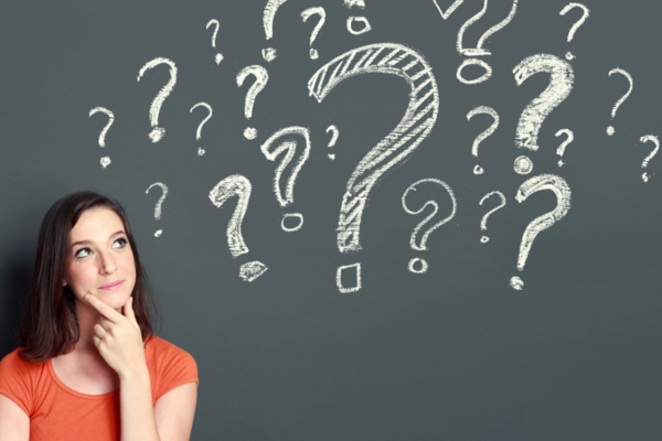 woman looking at question mark doodles on a chalkboard depicting HVAC Airflow FAQs