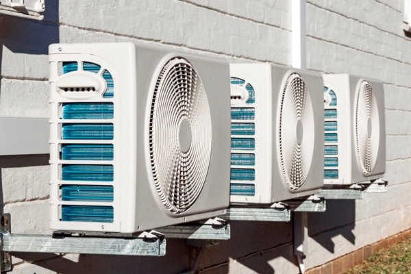 Three Newly Installed Outdoor Airconditioning Units Mounted on Wall