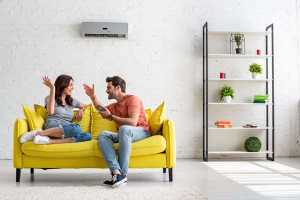 couple enjoying cool air in the living room with ductless AC