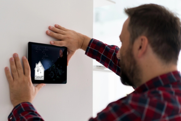 homeowner installing smart thermostat