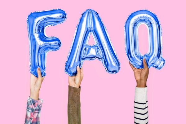 Hands holding FAQ word in balloon letters depicting Propane Outdoor Kitchen questions
