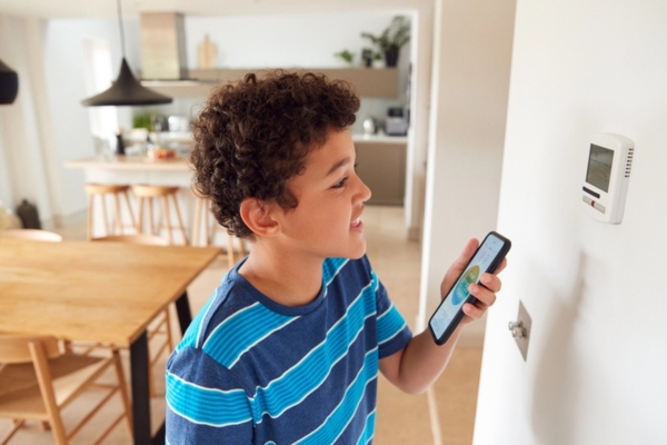 kid synching smart home thermostat to smart phone