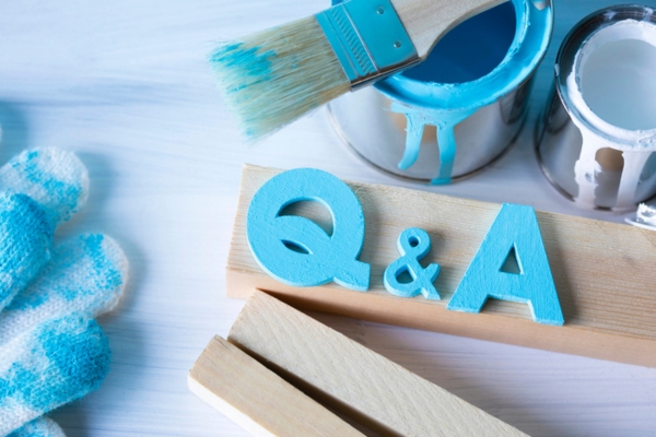 Q&A carved on wood and painted light blue depicting Backyard Propane Ideas FAQs