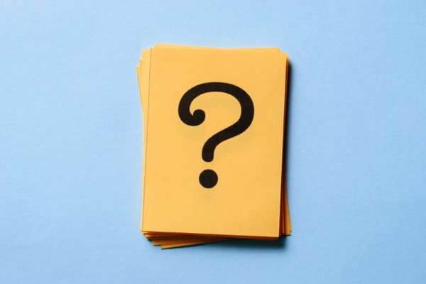 question mark on a stack of paper depicting Air Conditioning Sickness FAQs