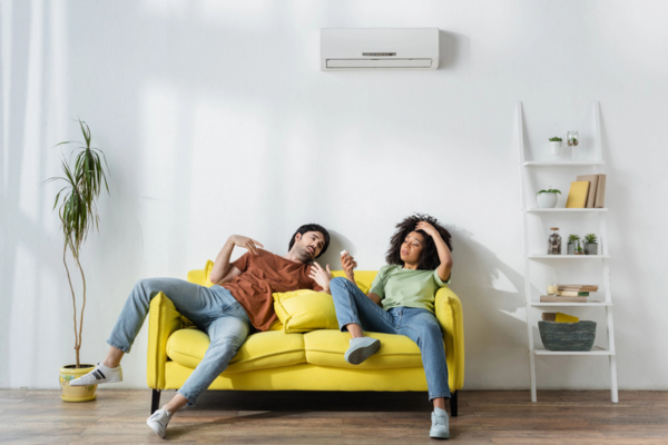 couple feeling warm indoors despite using air conditioner