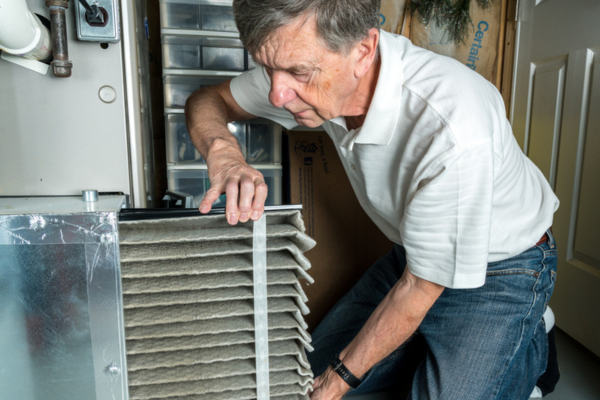 homeowner checking home HVAC filter