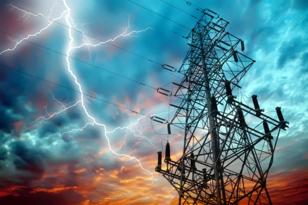 electrical grid lines against dark clouds with lightning