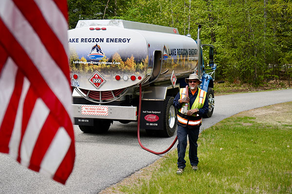 Glen, NH technician delivering heating oil from a service truck with a hose