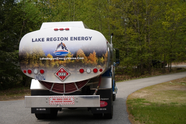 Glen, NH propane delivery truck parked near residential property for oil tank installation