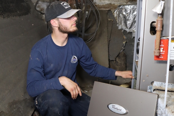 New Gloucester, ME technician performing heating and furnace repair in a residential basement